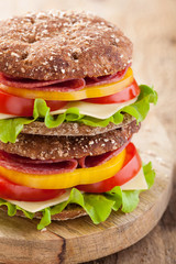healthy sandwich with salami tomato pepper and lettuce