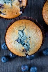 Blueberry muffins on wooden table from above