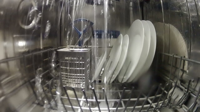 Dish washing machine with water streams, inside view