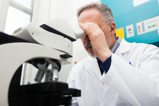 Man using a microscope in a laboratory