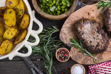 Grilled beef steak with fresh herbs and roasted potatoes