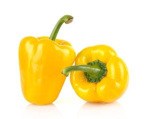 Studio shot of two yellow bell peppers isolated on white