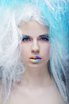 young woman with bright make up and creative hair