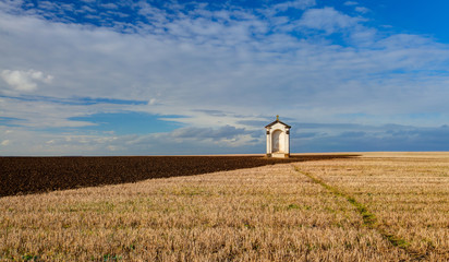 Fototapeta na wymiar A small chapel in the middle of fields
