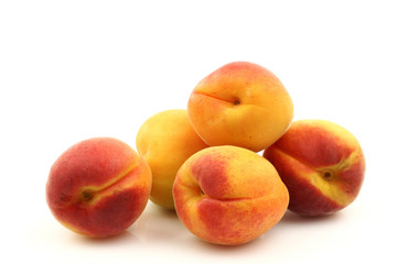 Fototapeta na wymiar fresh colorful apricots on a white background
