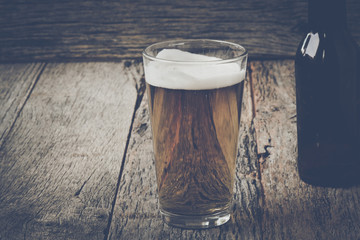 Pint of Pilsner Beer on Wood Background with Vintage Instagram F