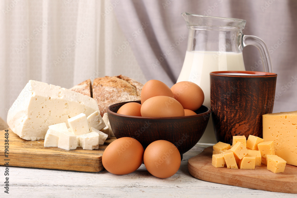 Poster tasty dairy products with bread on table on fabric background