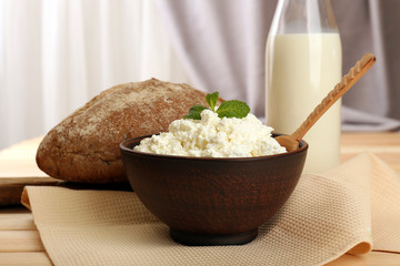 Tasty dairy products with bread on table close up