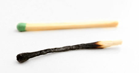 Match and burnt match isolated on white