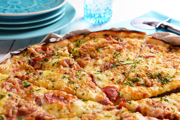 Tasty pizza with tableware on wooden table close up