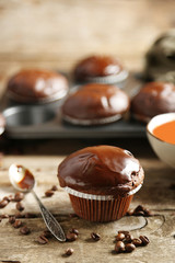Tasty homemade chocolate muffins on wooden table