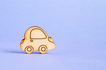 Wooden car icon on purple background
