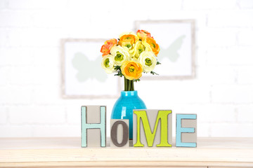 Home in colorful letters, in light white interior,