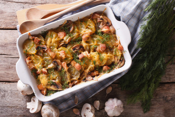 Vegetables baked with bacon and mushrooms closeup. top view