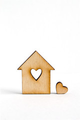 Obraz na płótnie Canvas Wooden house with hole in the form of heart with little heart on