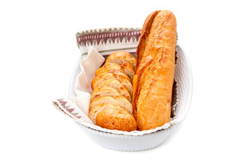 Crusty buns in basket on white background