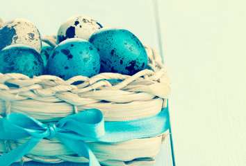 Colorful easter eggs in white basket