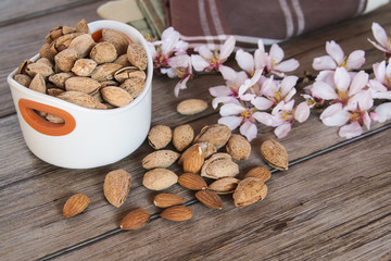 Almonds and flower tree in a wooden background