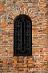 Fototapeta na wymiar Wall of red bricks with window