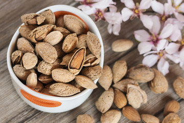 Almonds and flower tree in a wooden background