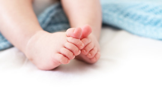 Baby feet on white background