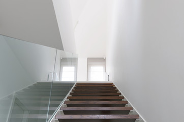 wooden staircase and glass balustrade