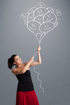 Happy woman holding smiling balloons drawing