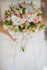 Beautiful wedding bouquet in hands of the bride