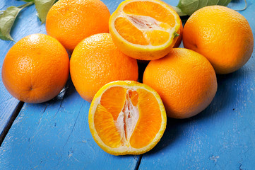 Blood oranges isolated on blue wooden background
