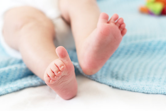 Baby feet on white background
