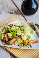 green salad with quail eggs, corn and sweet apple