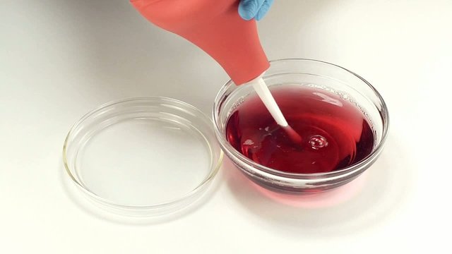 Enema is filling with red liquid