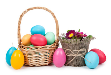 Easter eggs in a basket, flowers isolated on white background