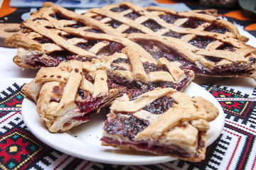 home-made cake with jam on a tablecloth