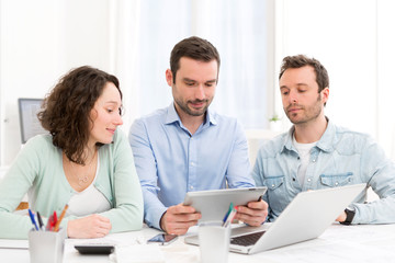 Two interns working together assisted by their course supervisor
