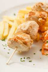 Chicken skewers with french fries