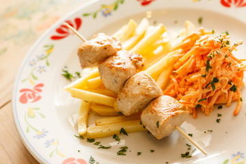 Chicken skewers with french fries