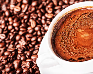 Coffee cup and  roasted coffee beans  can be used as a backgroun