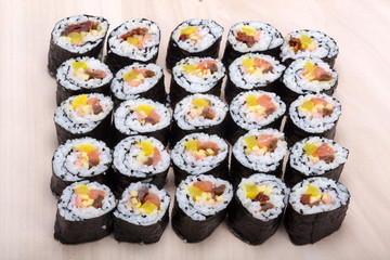 sushi fresh maki rolls isolated on wooden board