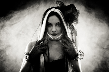 Portrait gothic girl in style clothes, shot over smoky backgroun
