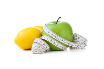 green apple and lemon with measuring tape