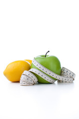 green apple and lemon with measuring tape