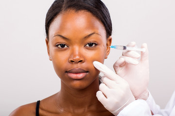 african girl woman receiving plastic surgery injection