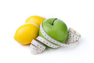green apple and lemon with measuring tape