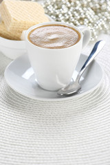 cup of coffee  on a white wicker a mat