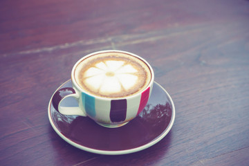 Coffee cup on table in cafe with vintage color tone