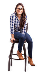 Cheerful woman sitting on a chair in a studio and smiling