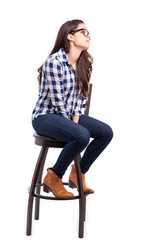 Fototapeta premium Young woman sitting on a chair