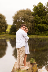 Fototapeta premium young couple standing on river pier