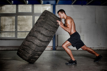 crossfit training - man flipping tire